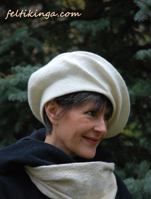 Woman in a sculptured white hat.